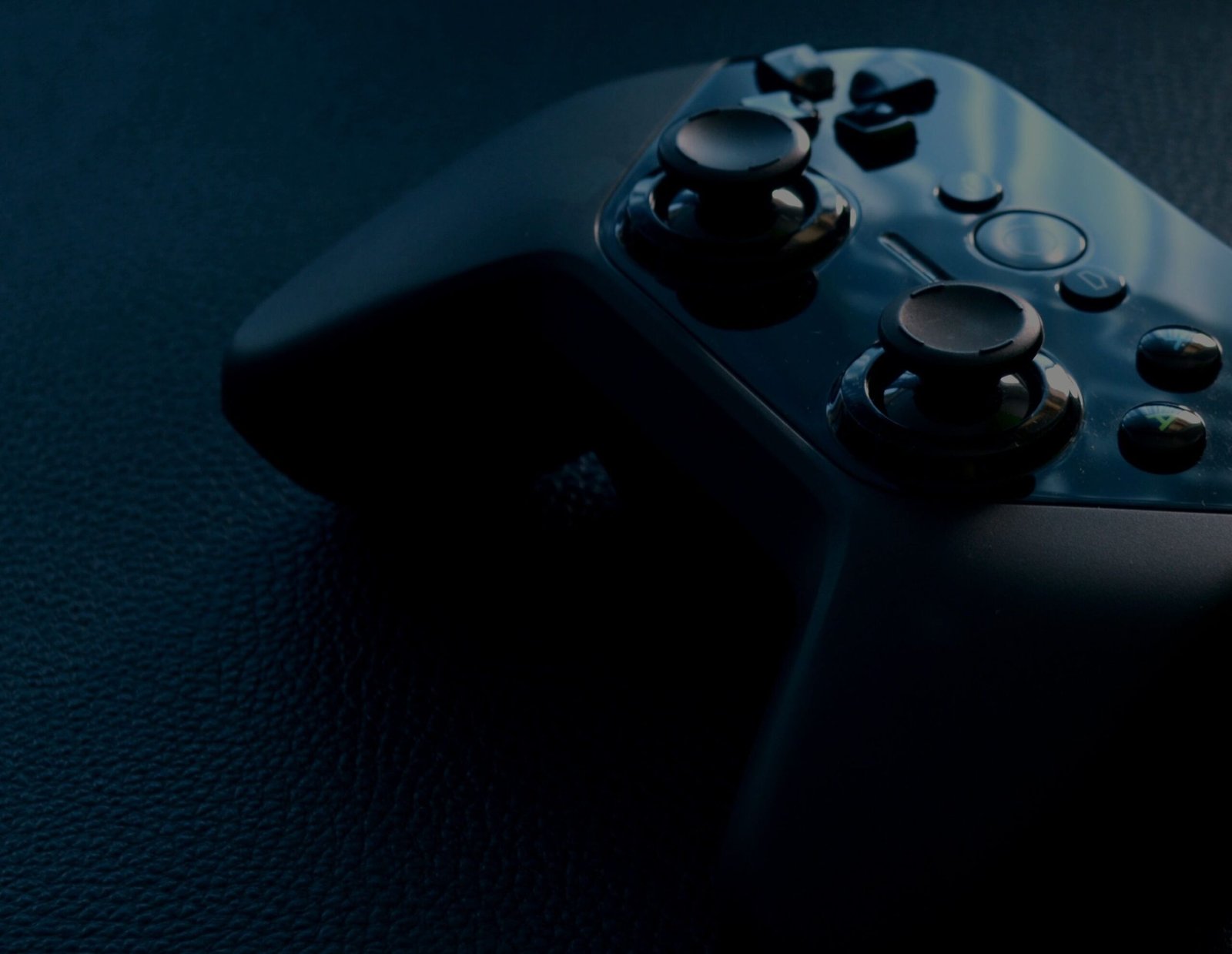 Black wireless game controller (stock photo, illustrative)